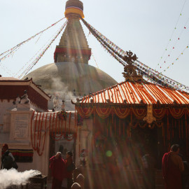 Buddhist monks and pilgrims by the Big Stupa in Kathmandu, Nepal