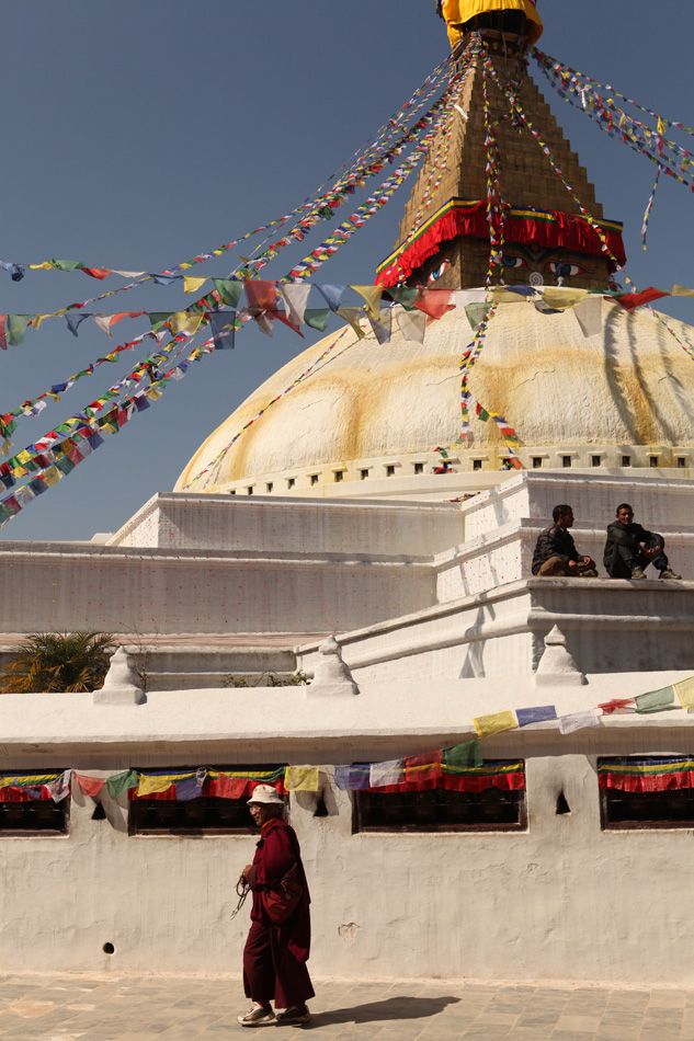 Monks and pilgrims by the Big Stupa in Kathmandu, Nepal