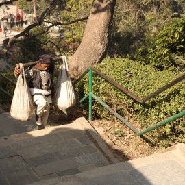 Resident of Kathmandu, Nepal, carrying sacks on his shoulders.
